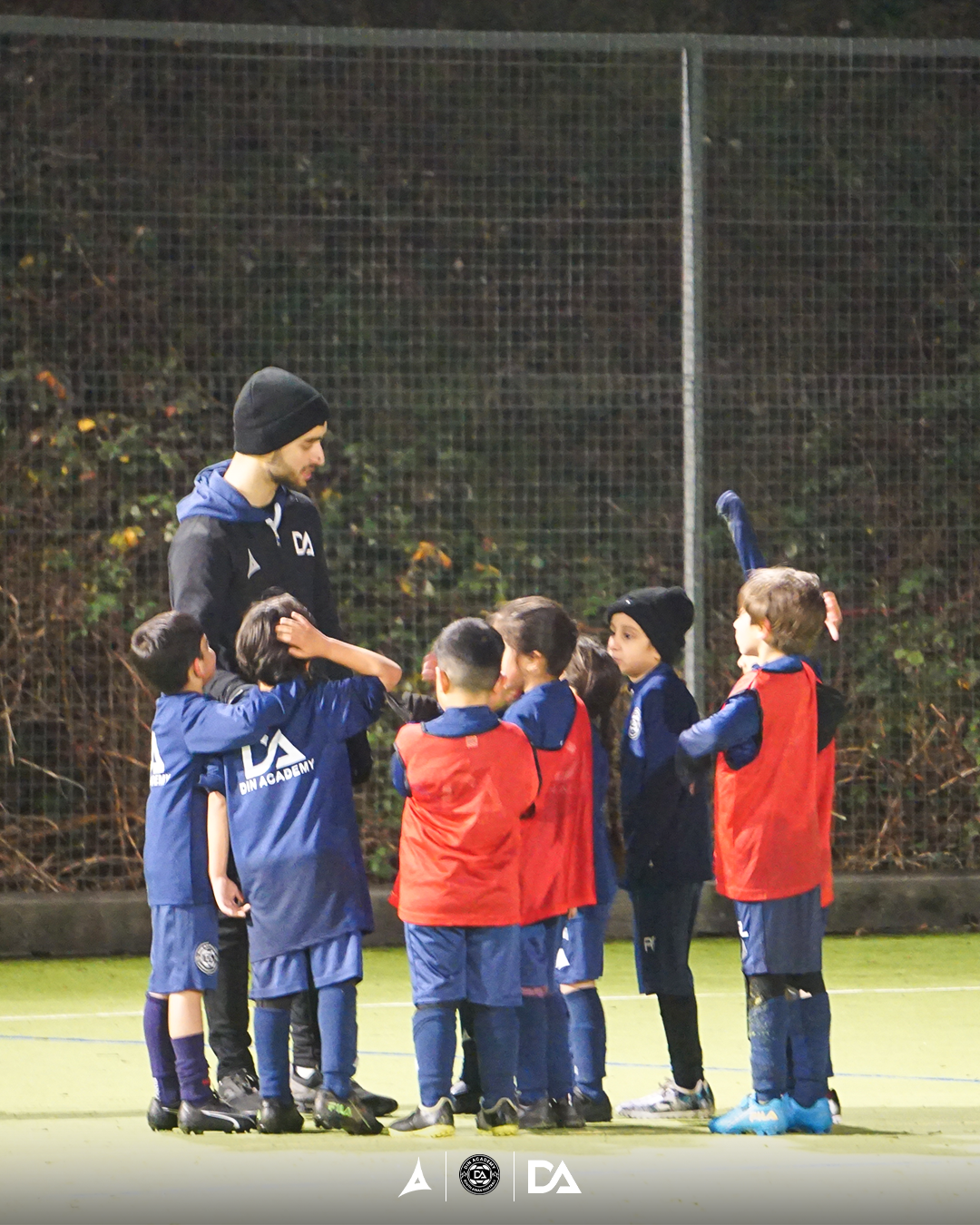 Elite football training session at night with dramatic lighting
